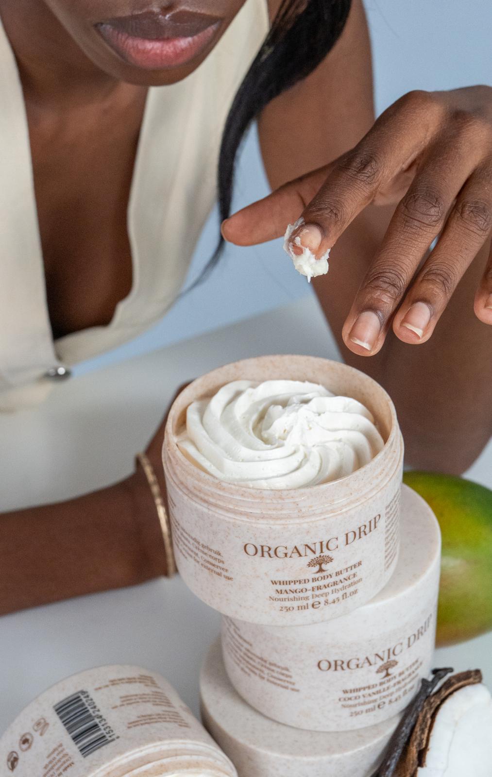 Close-up of Organic Drip whipped body butter texture with product jars